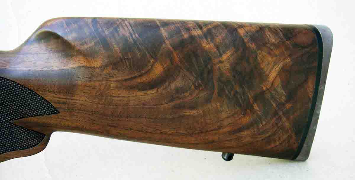 The stock is constructed of C grade American black walnut with a curved pistol grip and period-style cut checkering.
